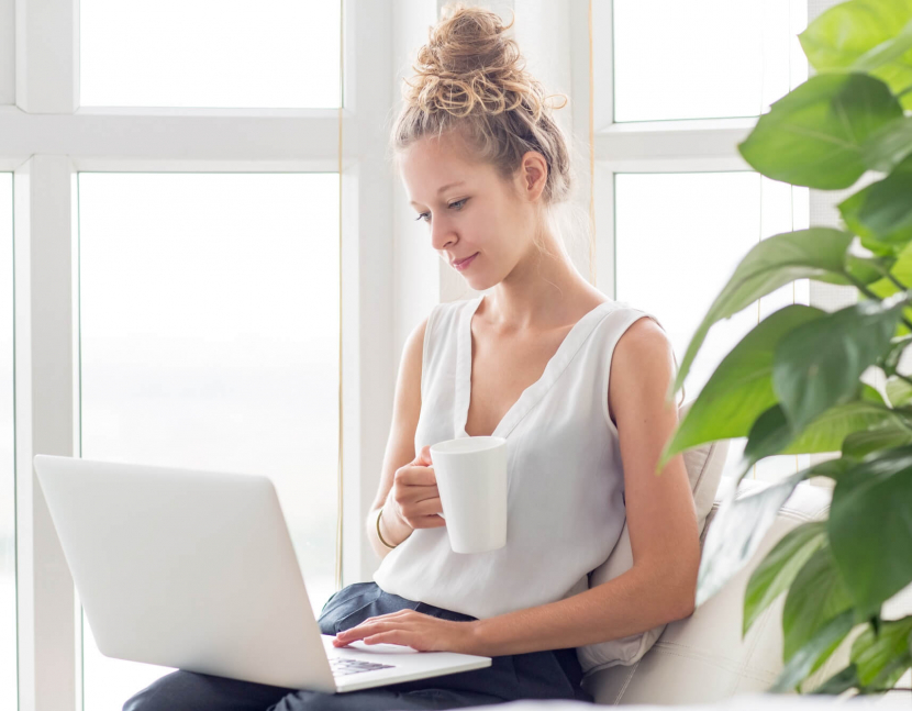 woman-working-on-laptop-and-drinking-tea-on-loggia (1)